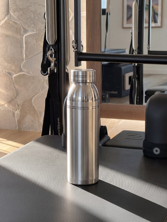 Silver bottle in a sunlit exercise studio